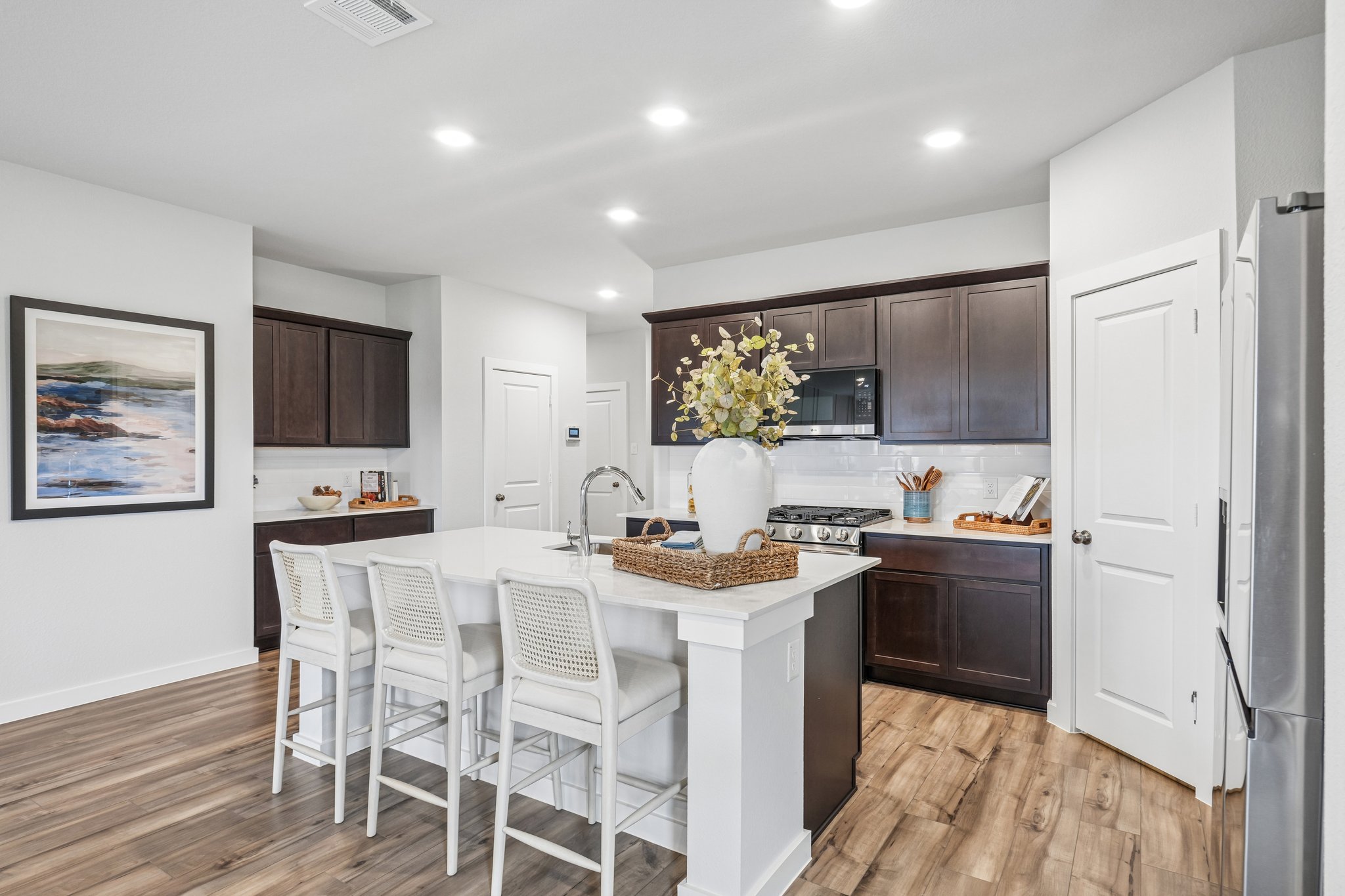 A kitchen with a dining table and chairs.