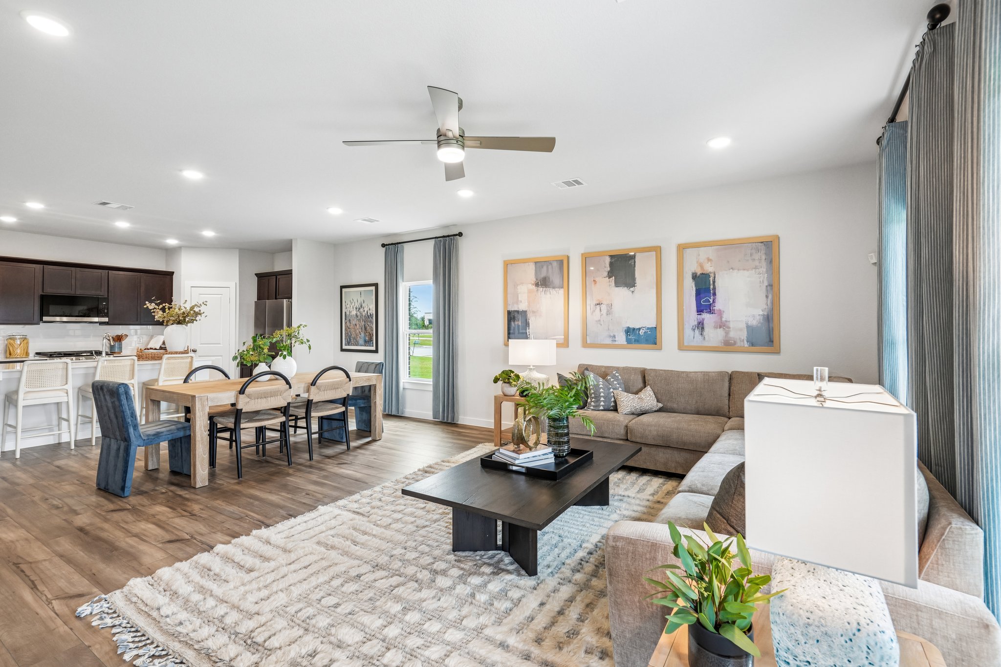 A large living room with a rug and a table.