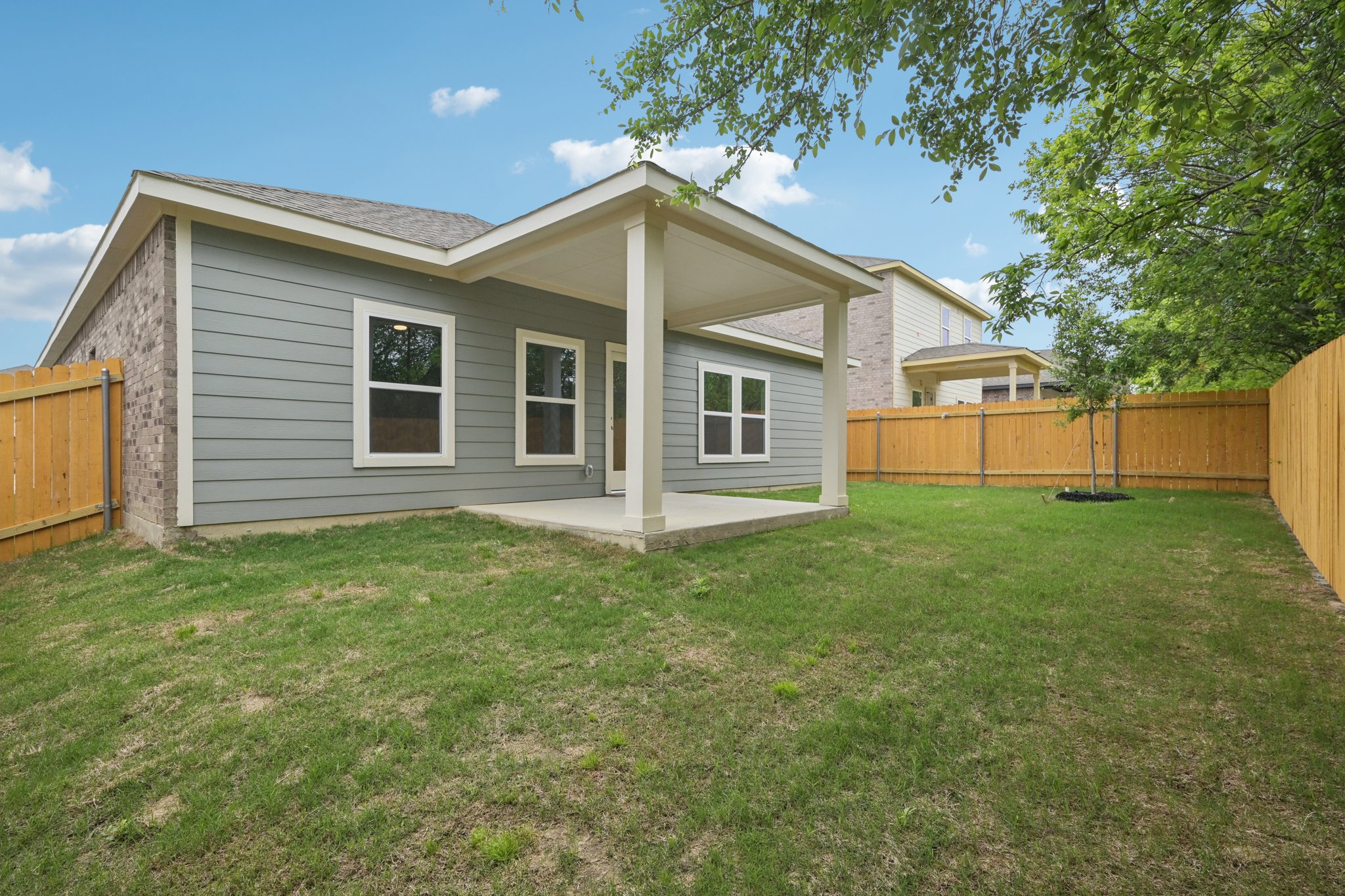 A house with a fence and trees.