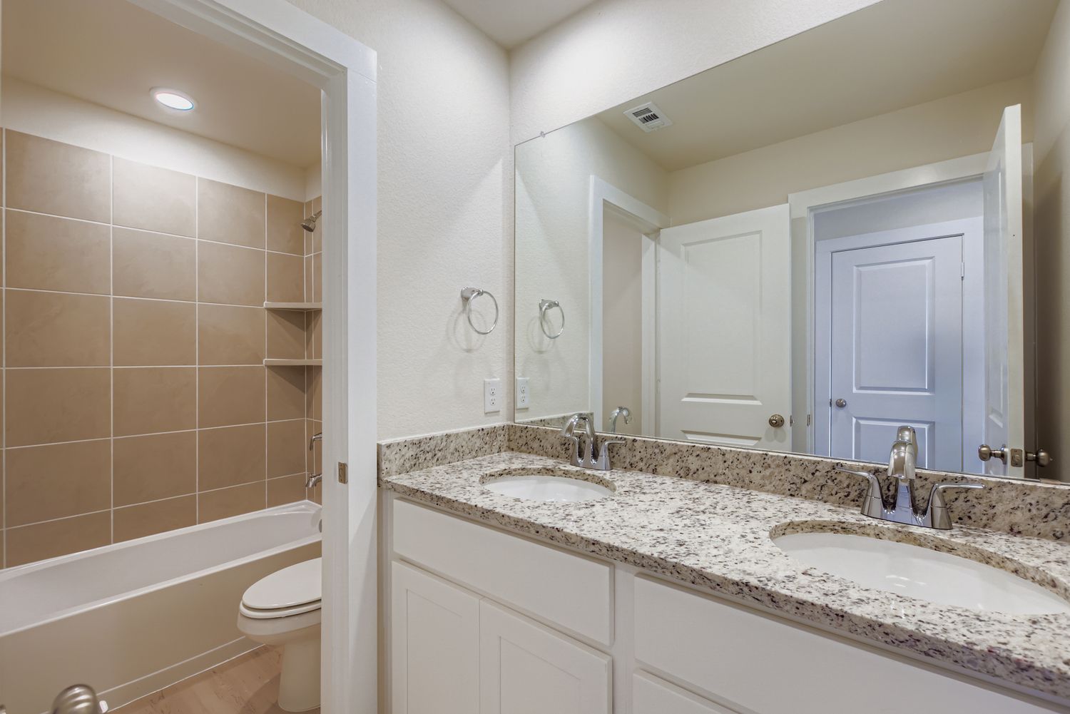 A bathroom with a marble countertop.