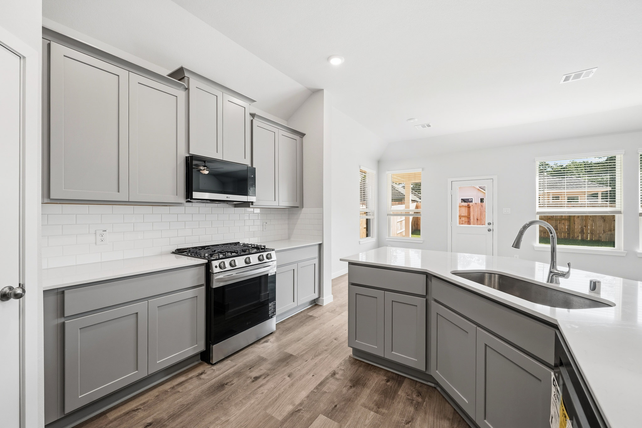 A kitchen with white cabinets.
