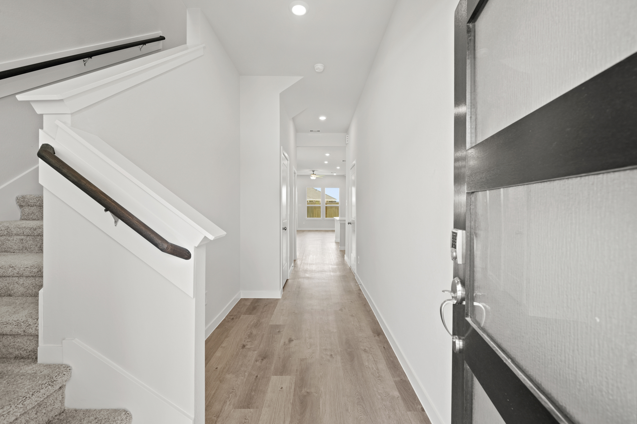 A hallway with white walls.