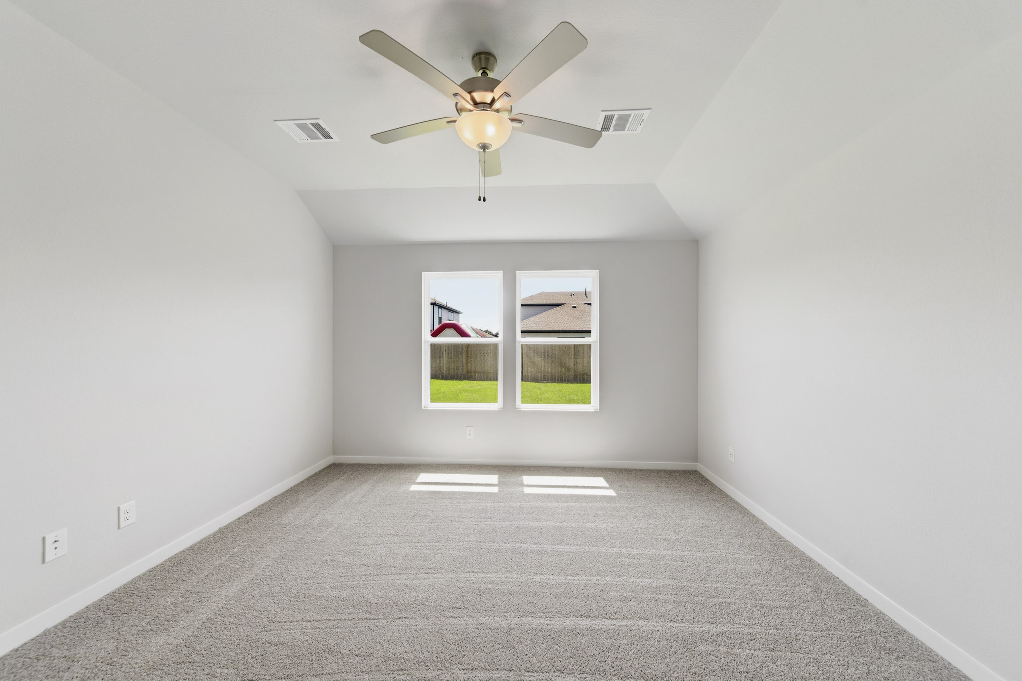 A room with a ceiling fan and a window.
