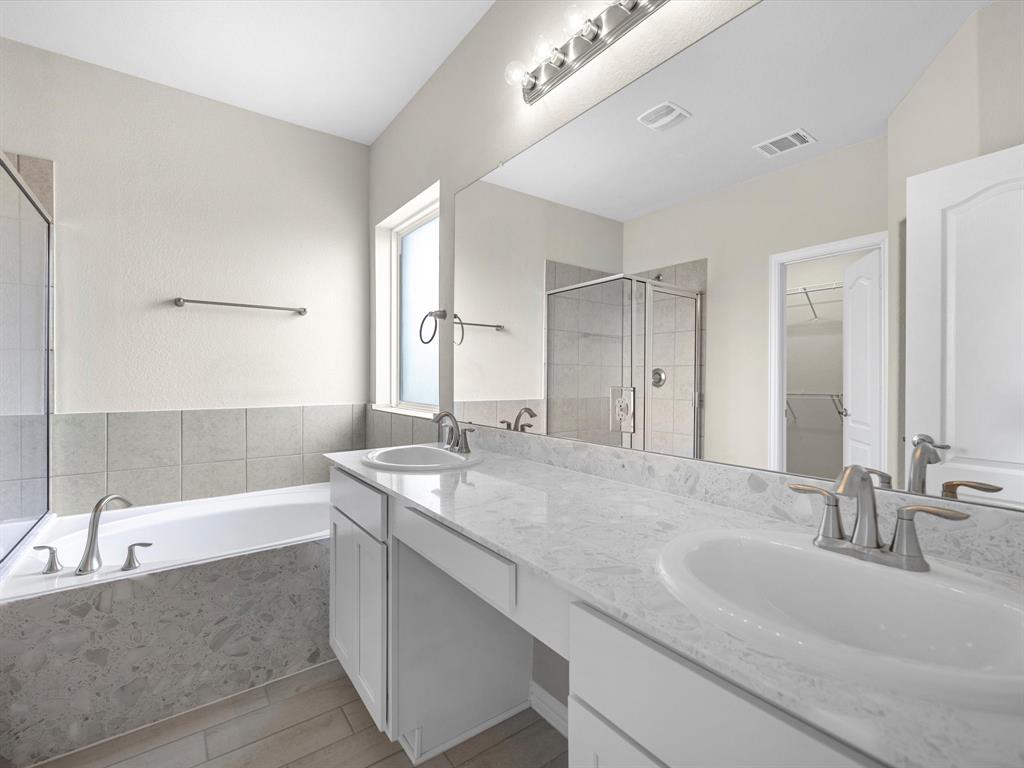 A bathroom with a tub sink and a bathtub.