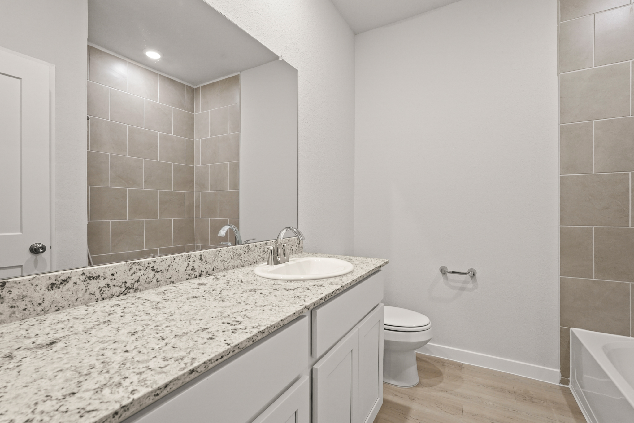 A bathroom with a marble countertop.