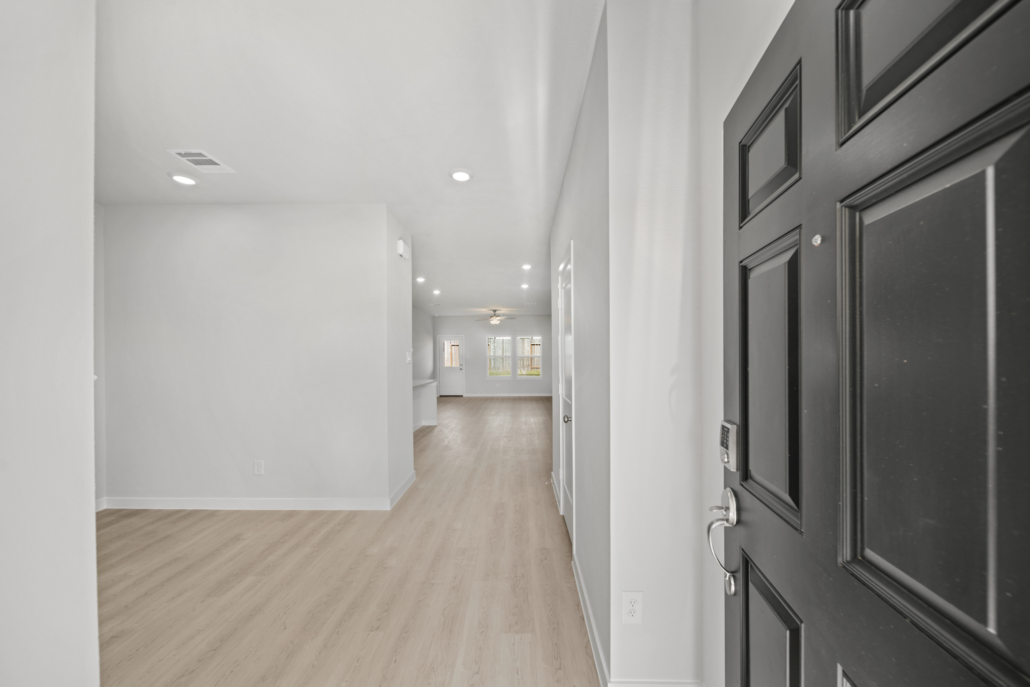 A hallway with white walls.