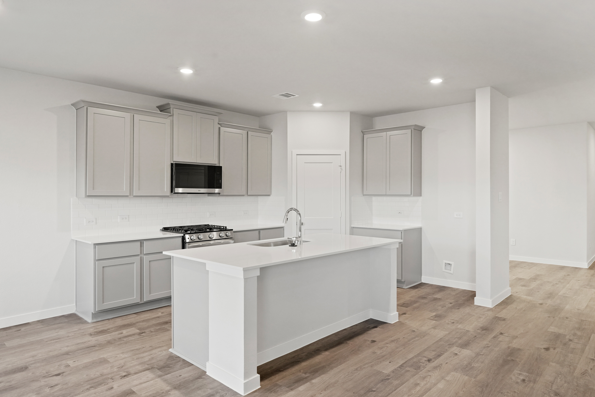A kitchen with white cabinets.