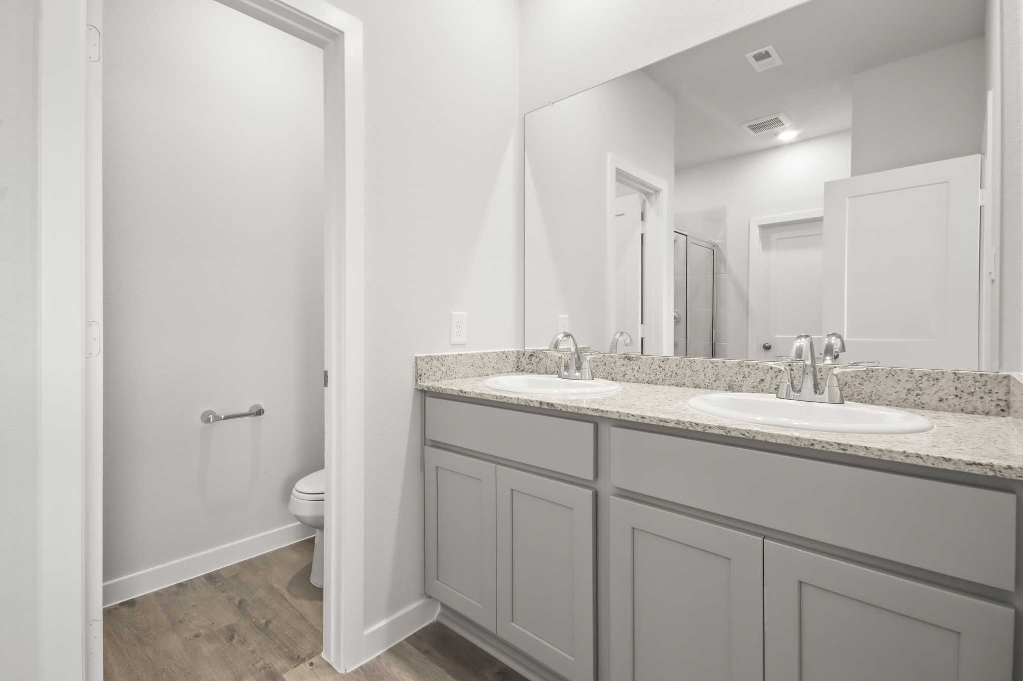 A bathroom with a large mirror.