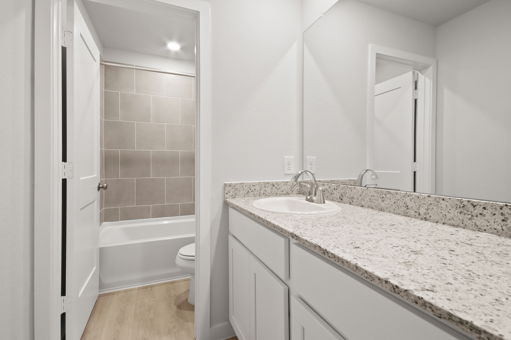 A bathroom with a marble countertop.