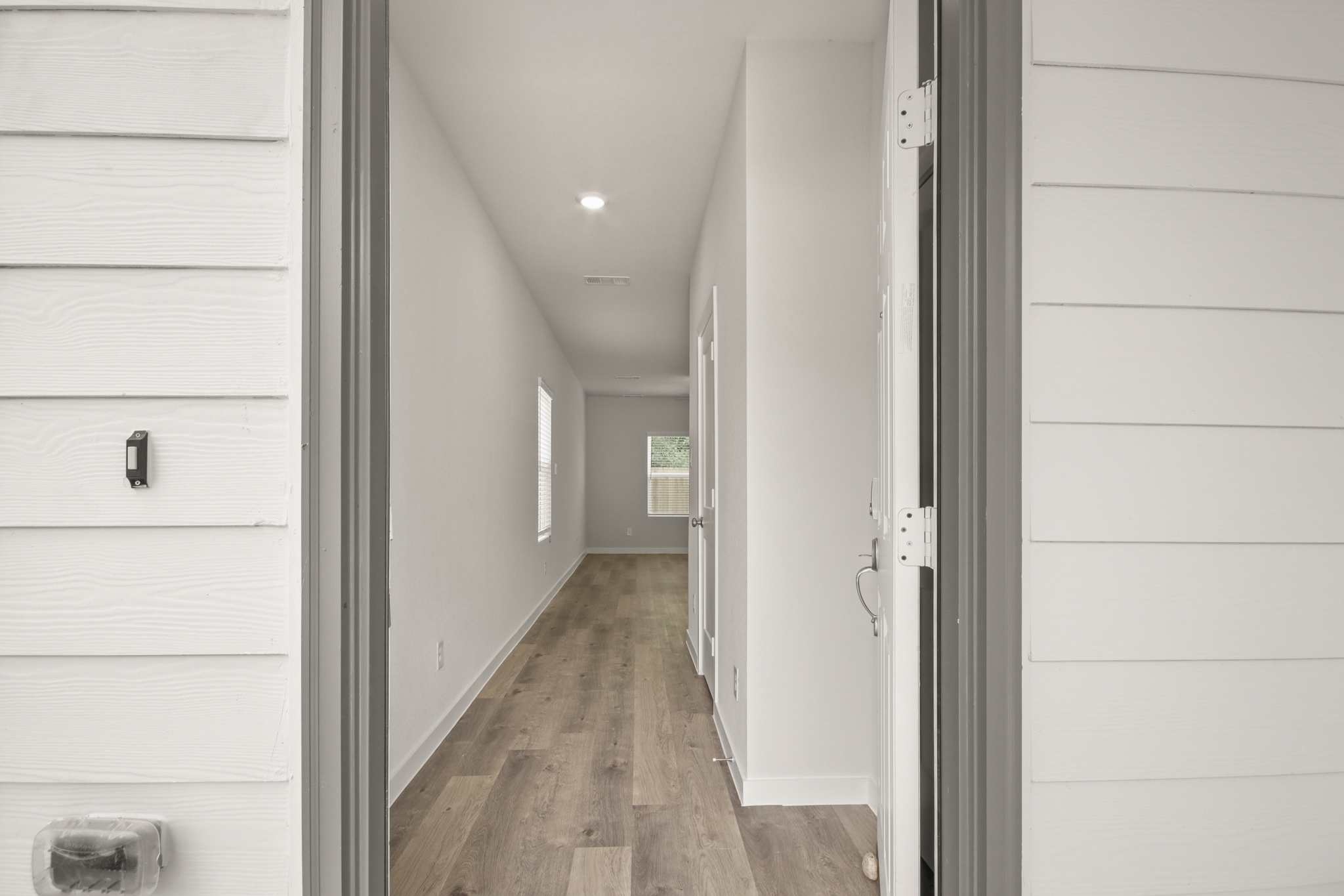 A hallway with white walls.
