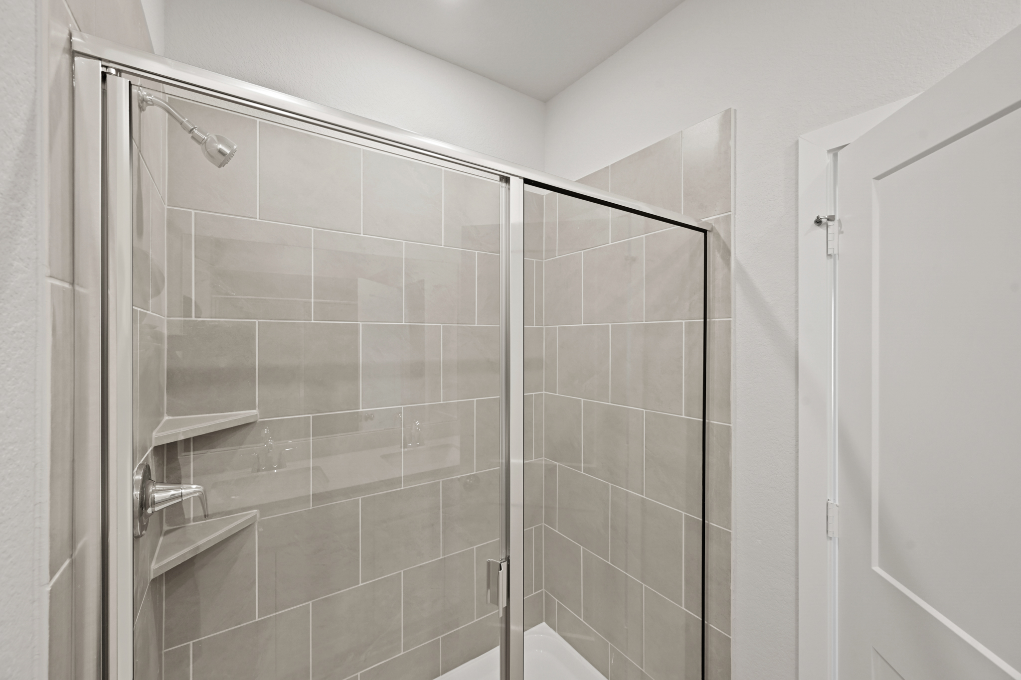 A shower with a glass door.
