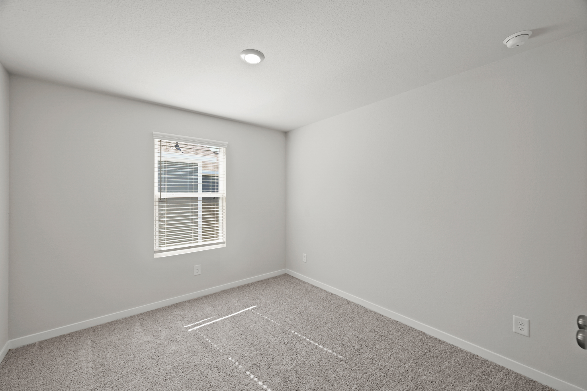 A room with a window and a tile floor.