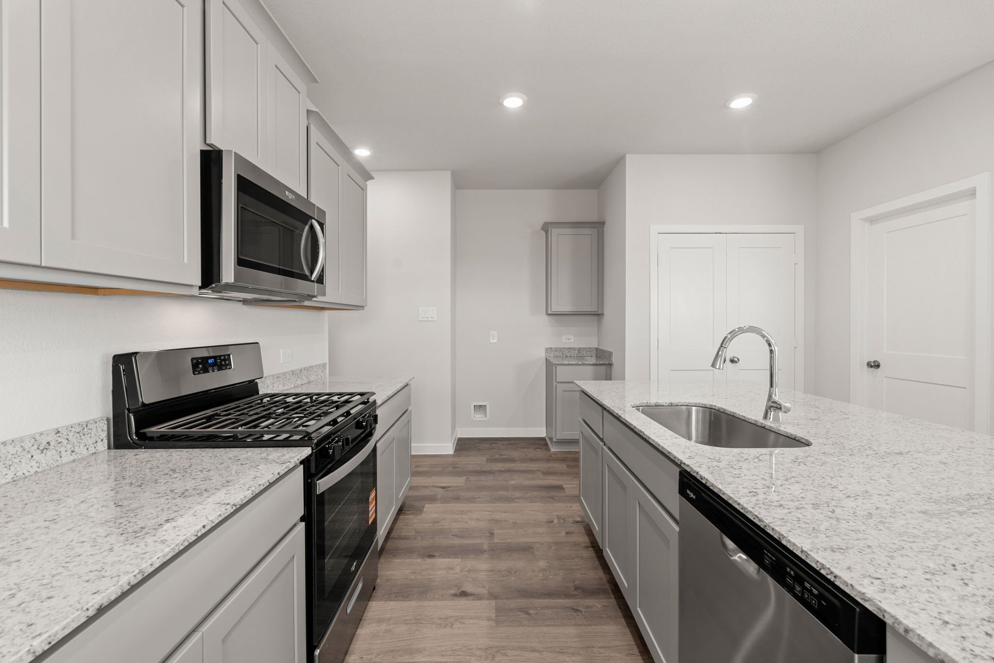 A kitchen with white cabinets.