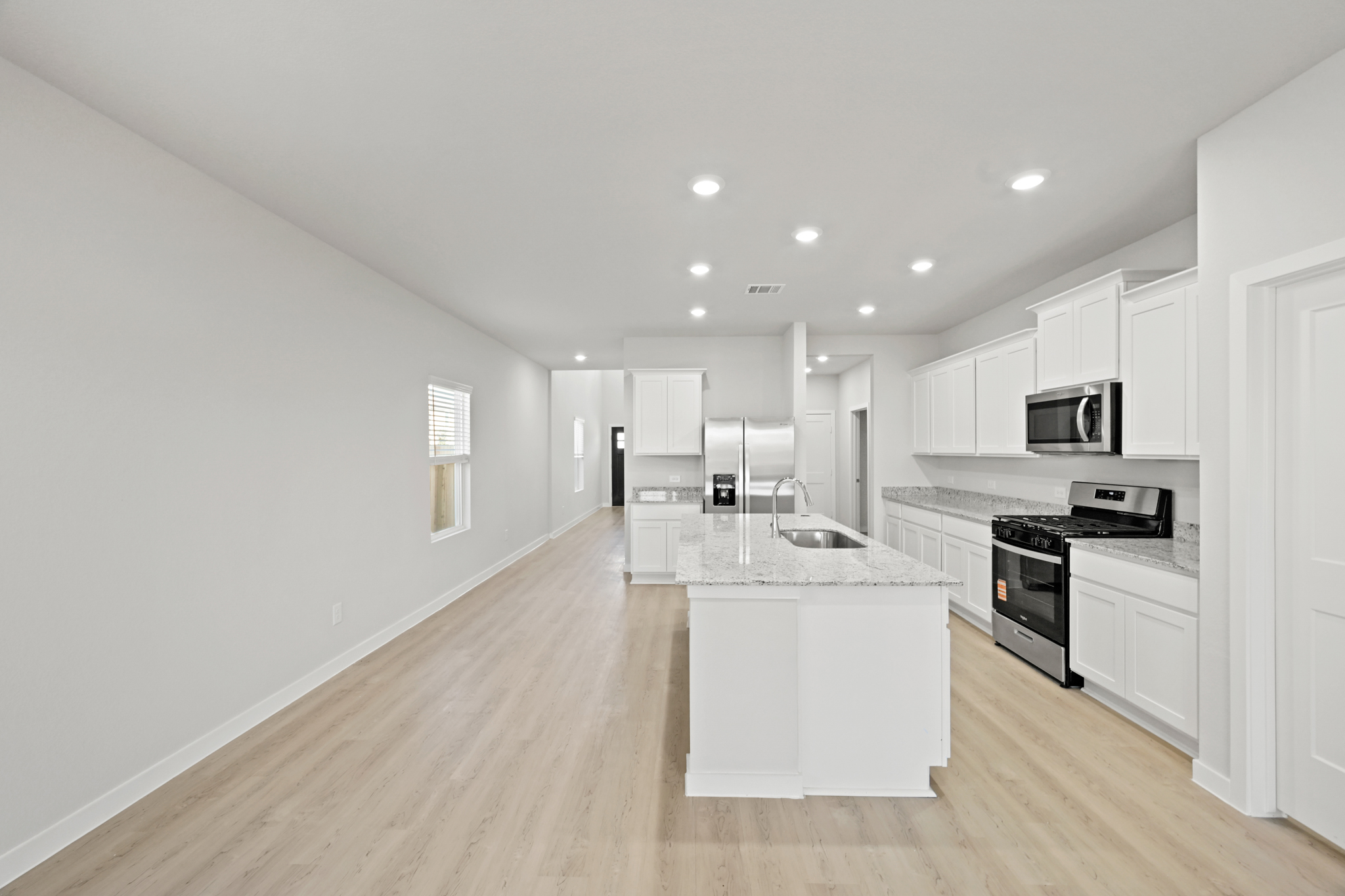 A kitchen with white cabinets.