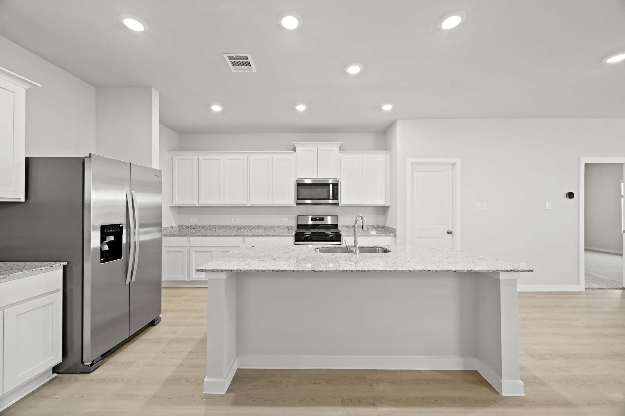 A kitchen with white cabinets.