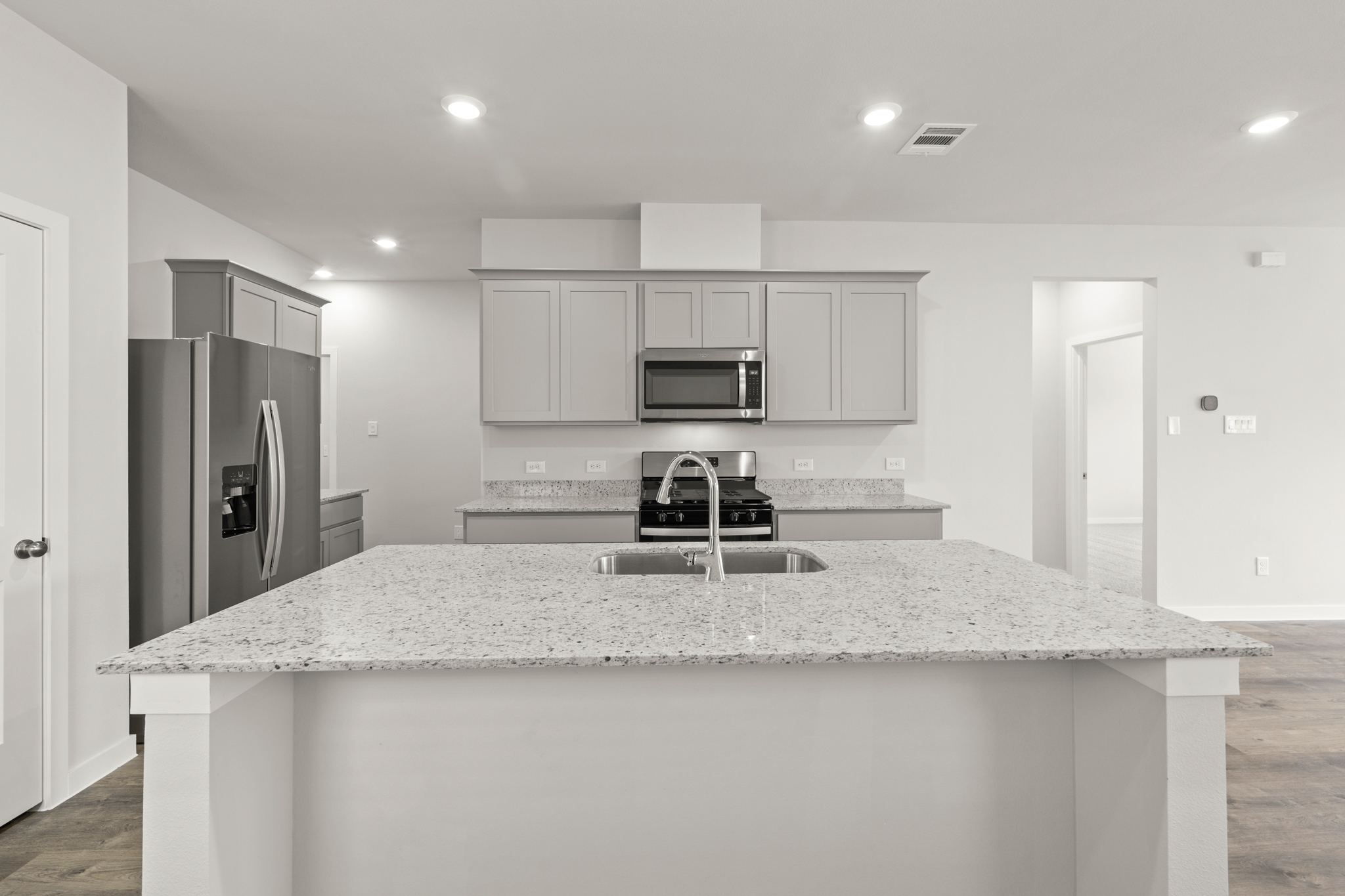 A kitchen with a marble counter top.