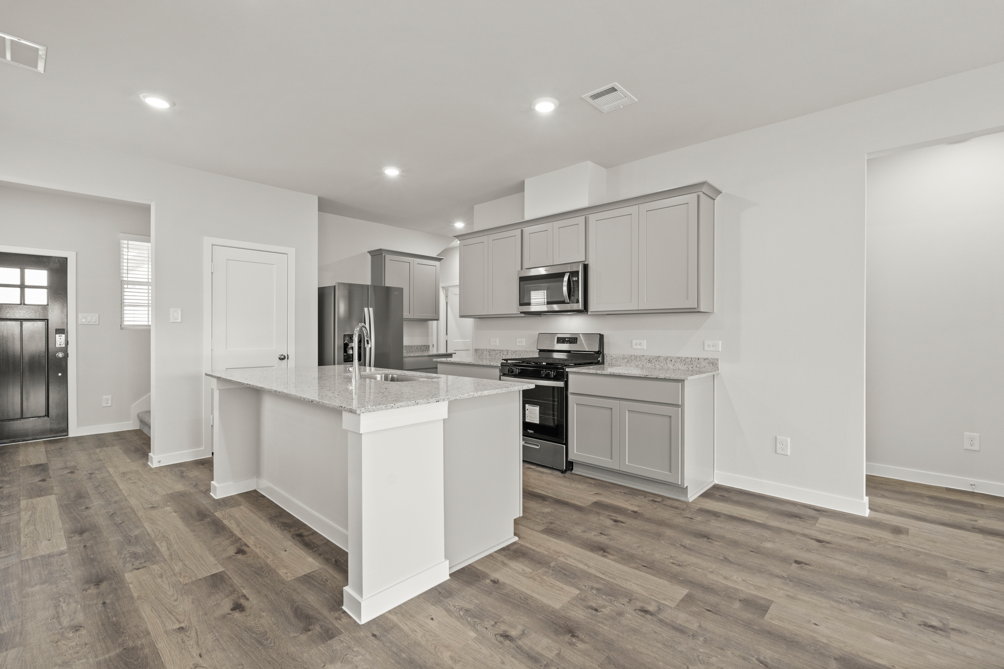A kitchen with white cabinets.