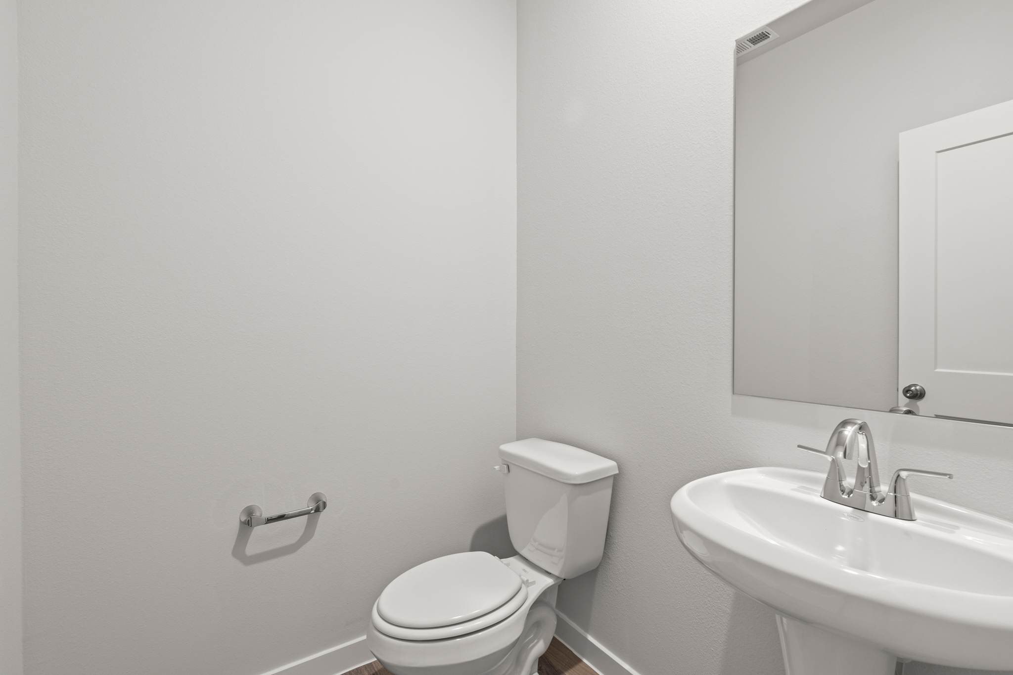 A bathroom with a toilet and sink.