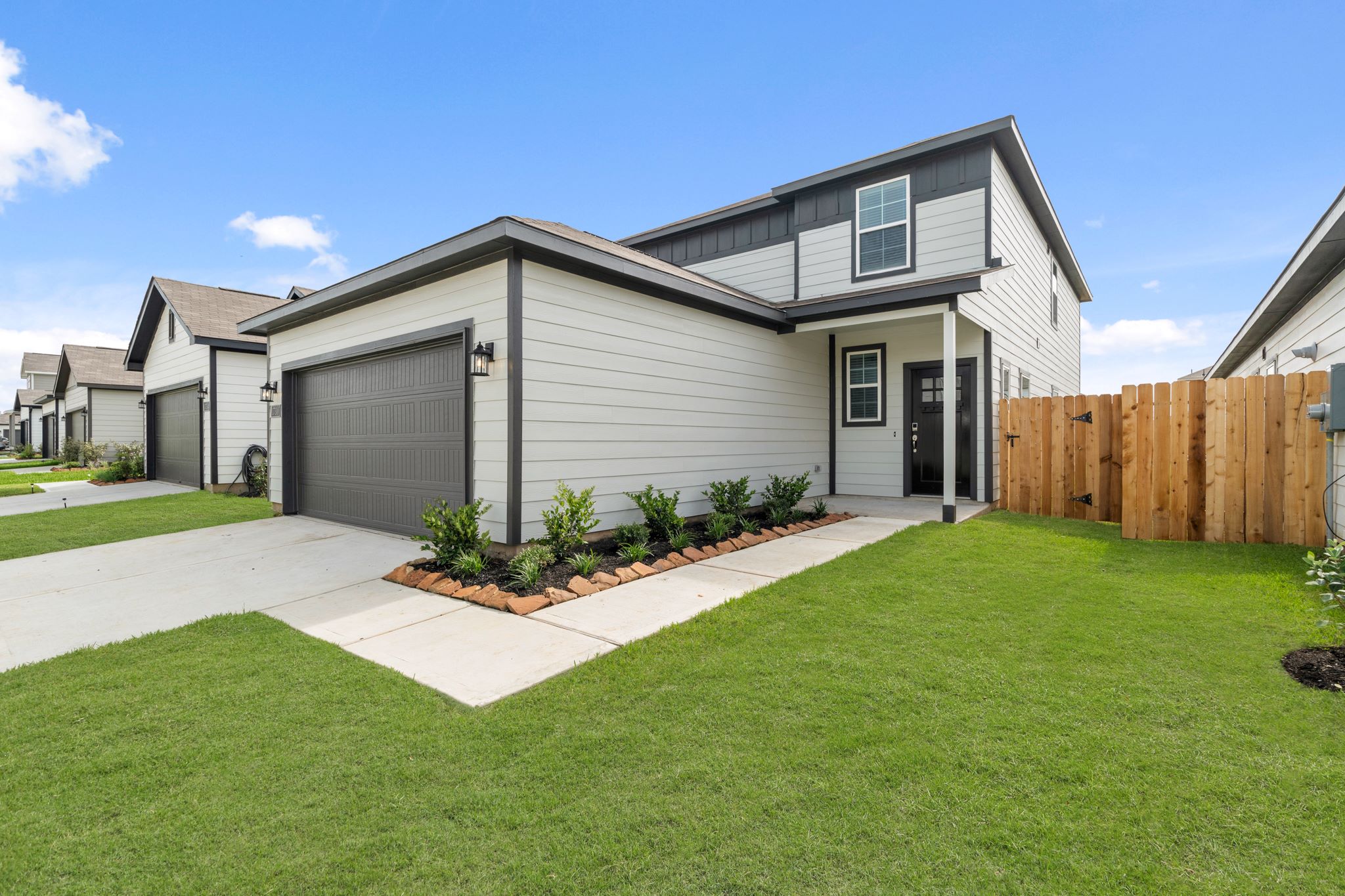 A house with a fence and a lawn.