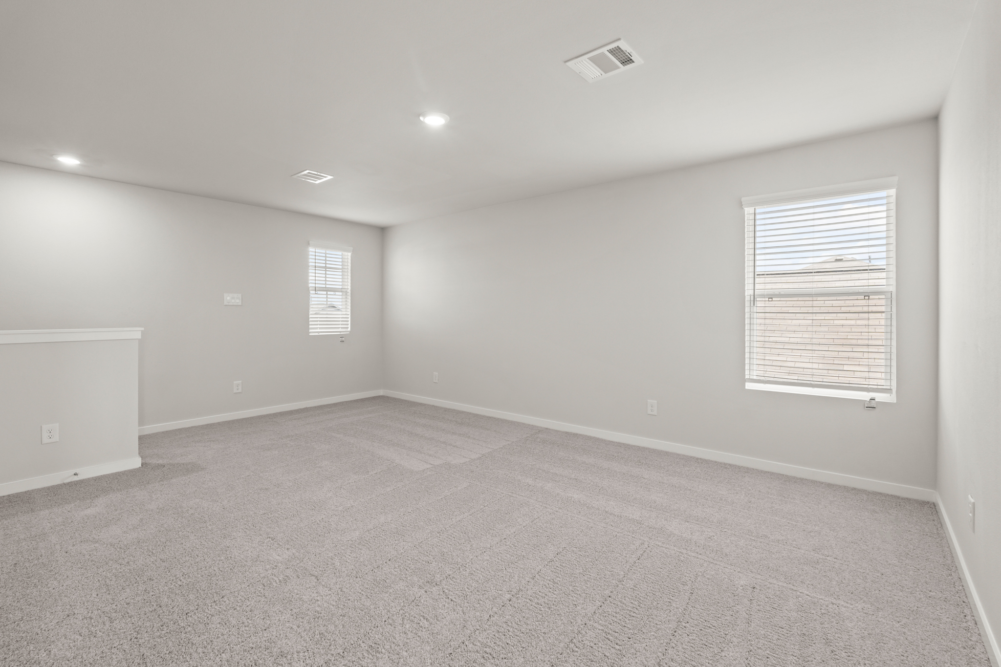 A room with a carpet and a window.