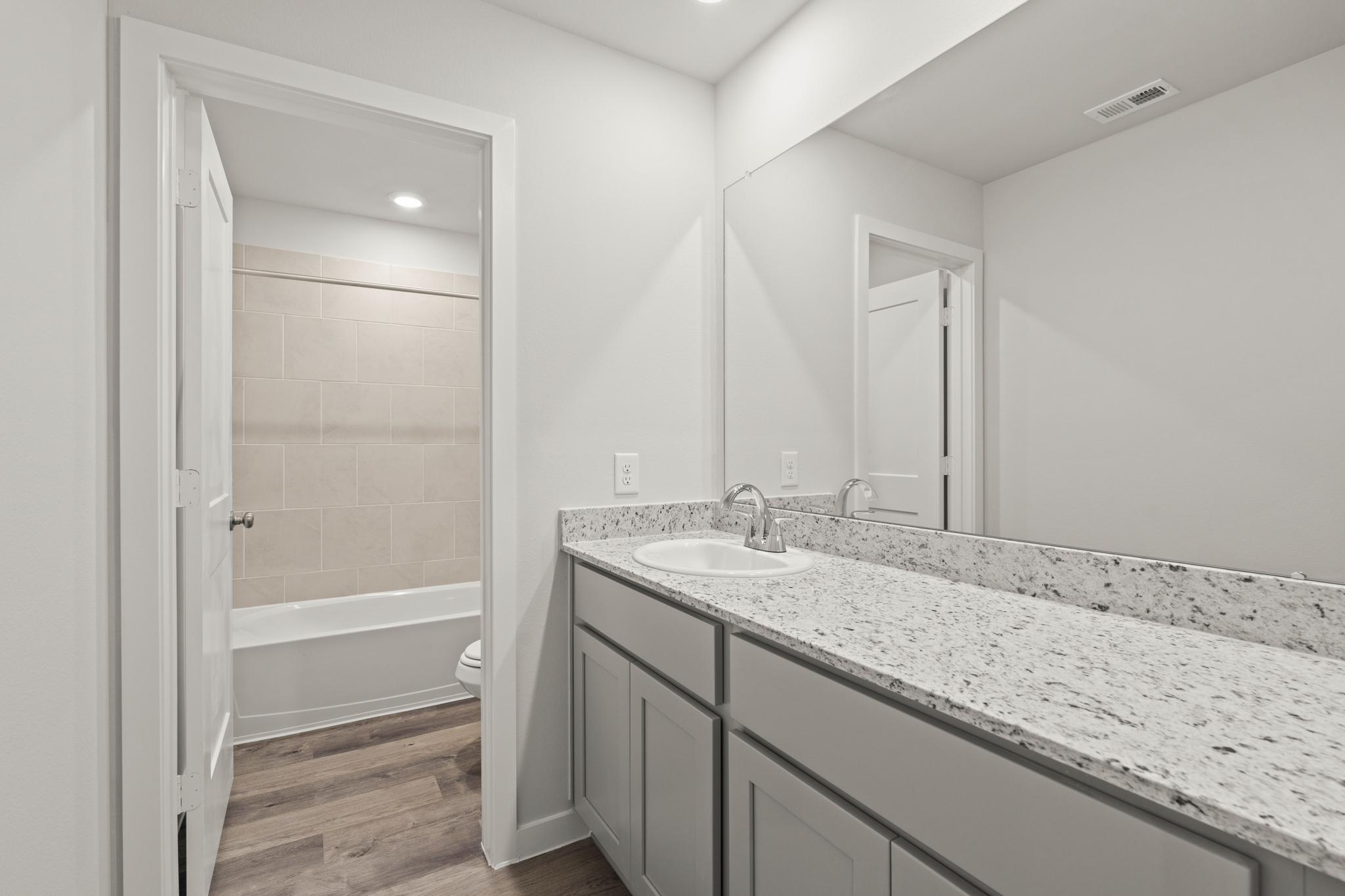 A bathroom with a marble countertop.