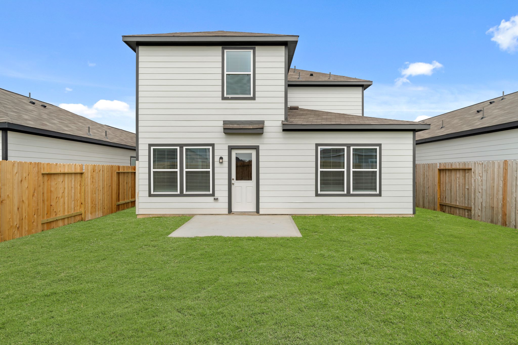 A house with a green lawn.