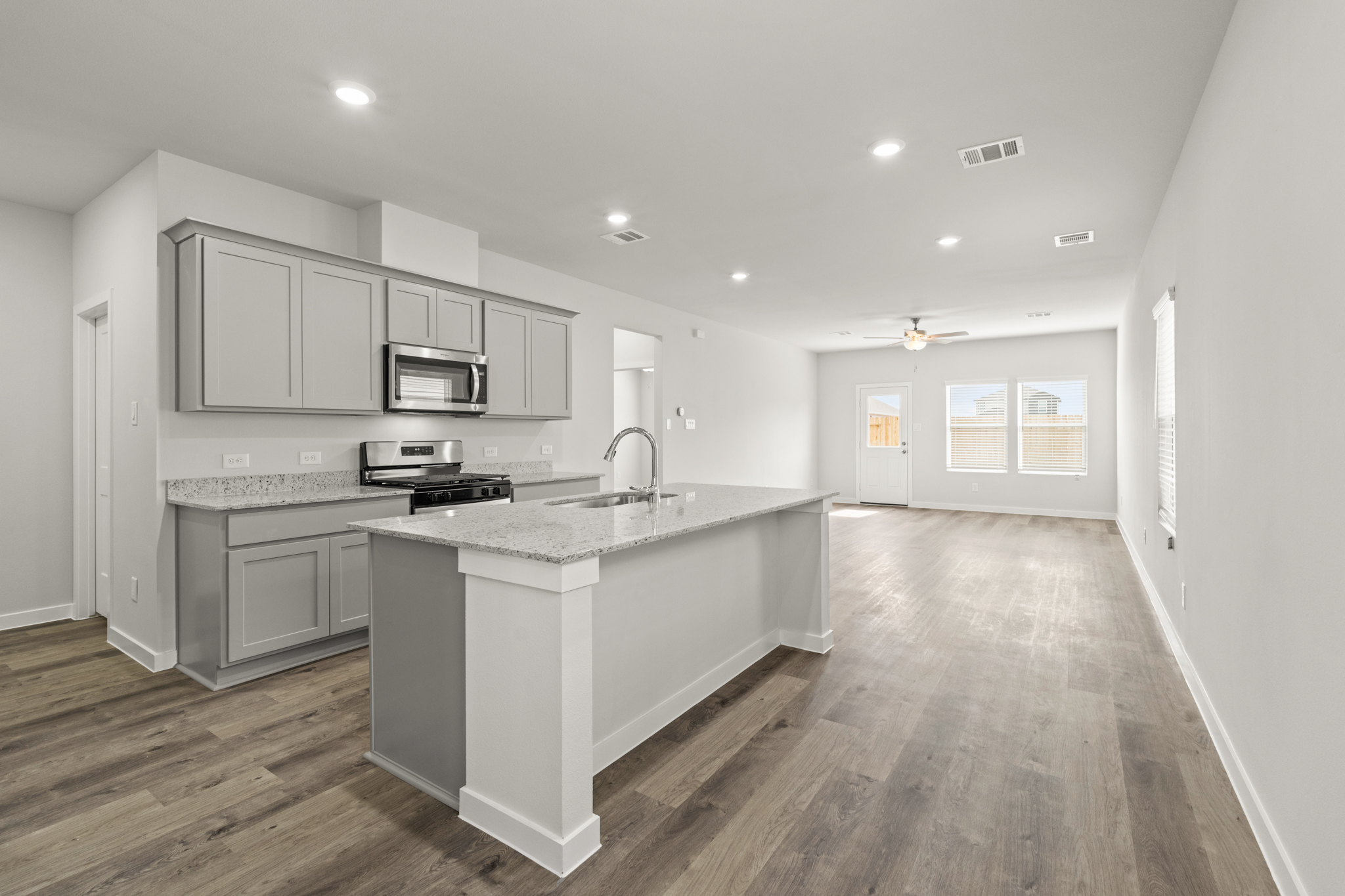 A kitchen with white cabinets.