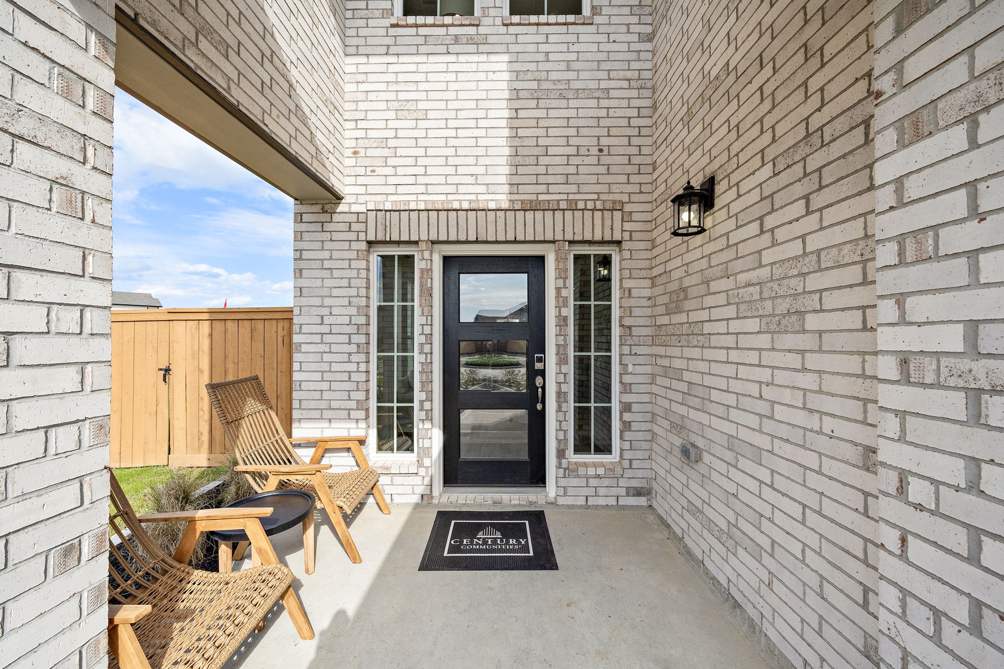 A patio with chairs and tables outside a building.
