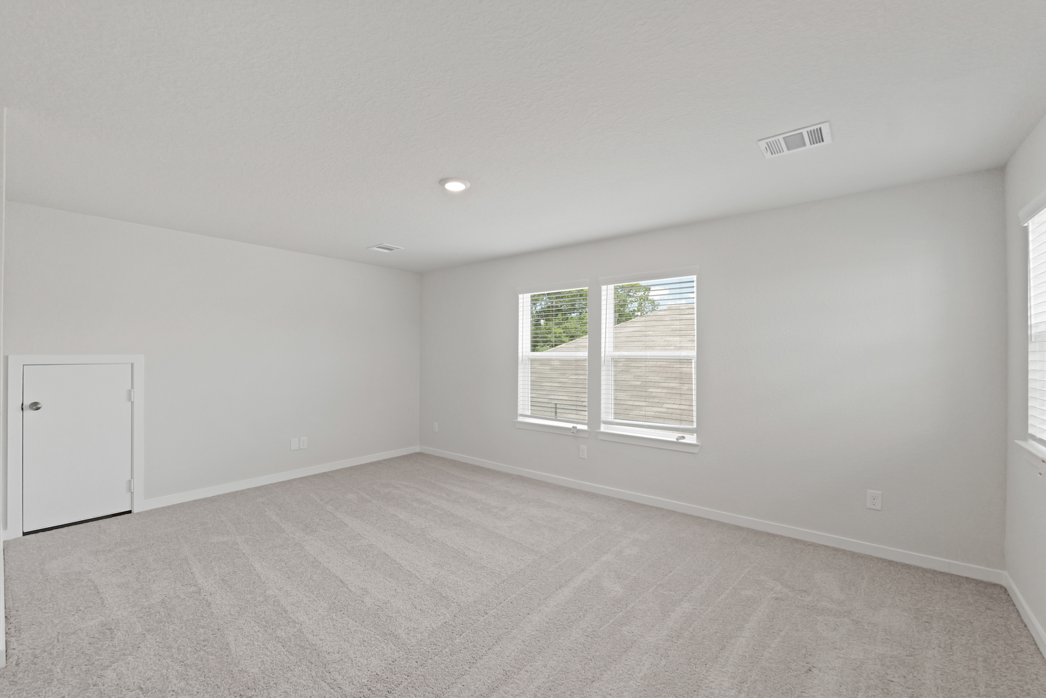 A room with a window and a door.