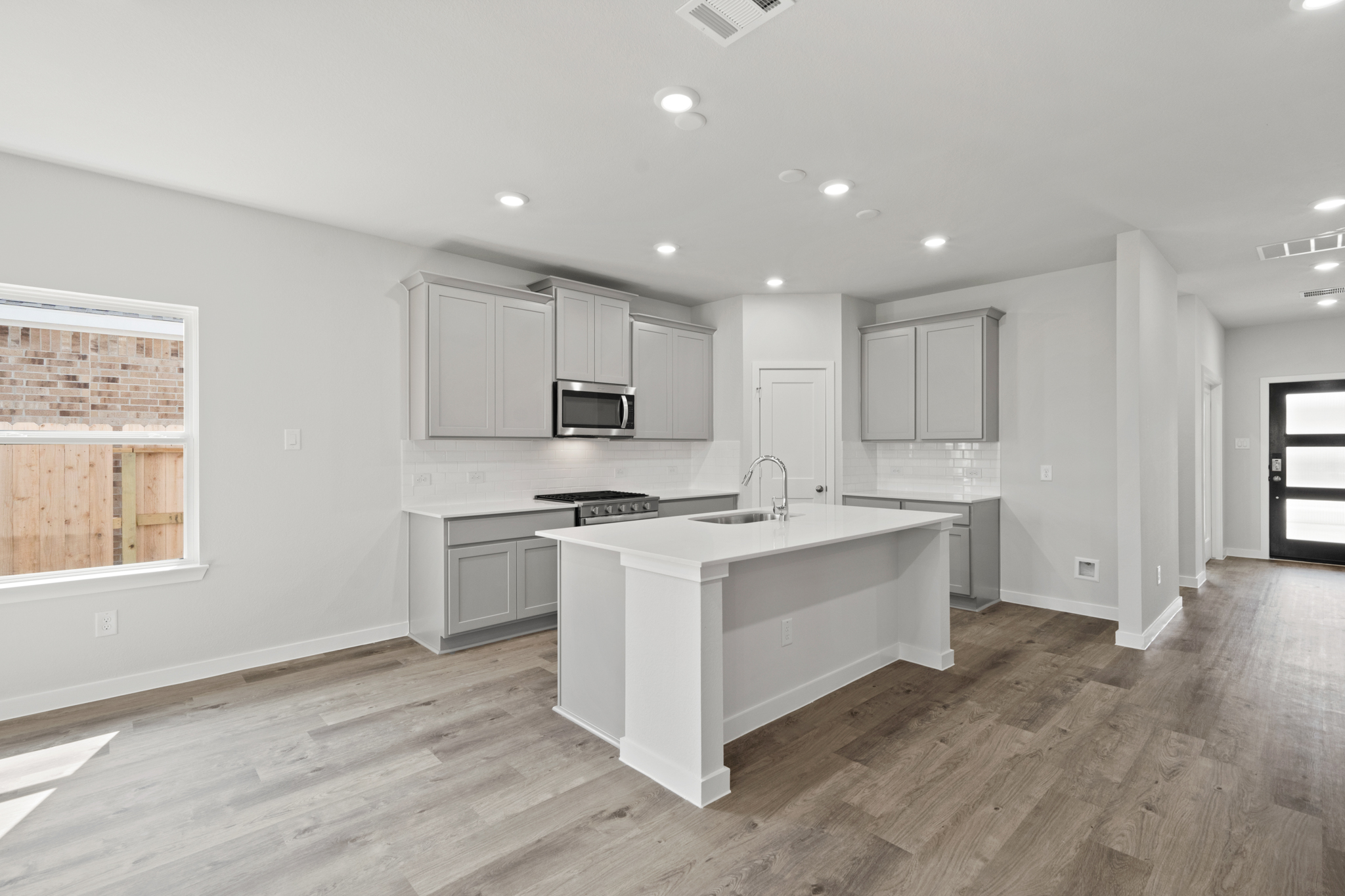 A kitchen with white cabinets.