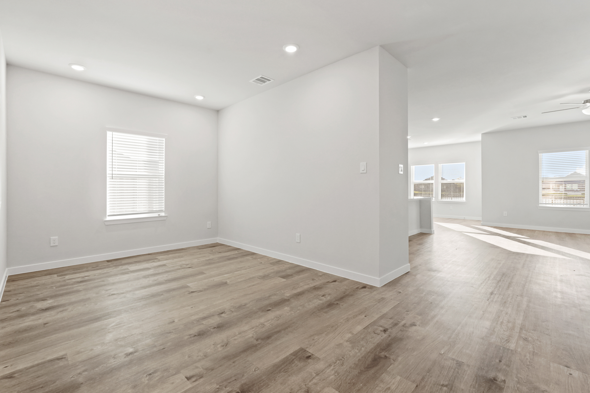 A room with a wood floor and white walls.