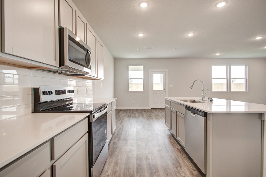 A kitchen with white cabinets.