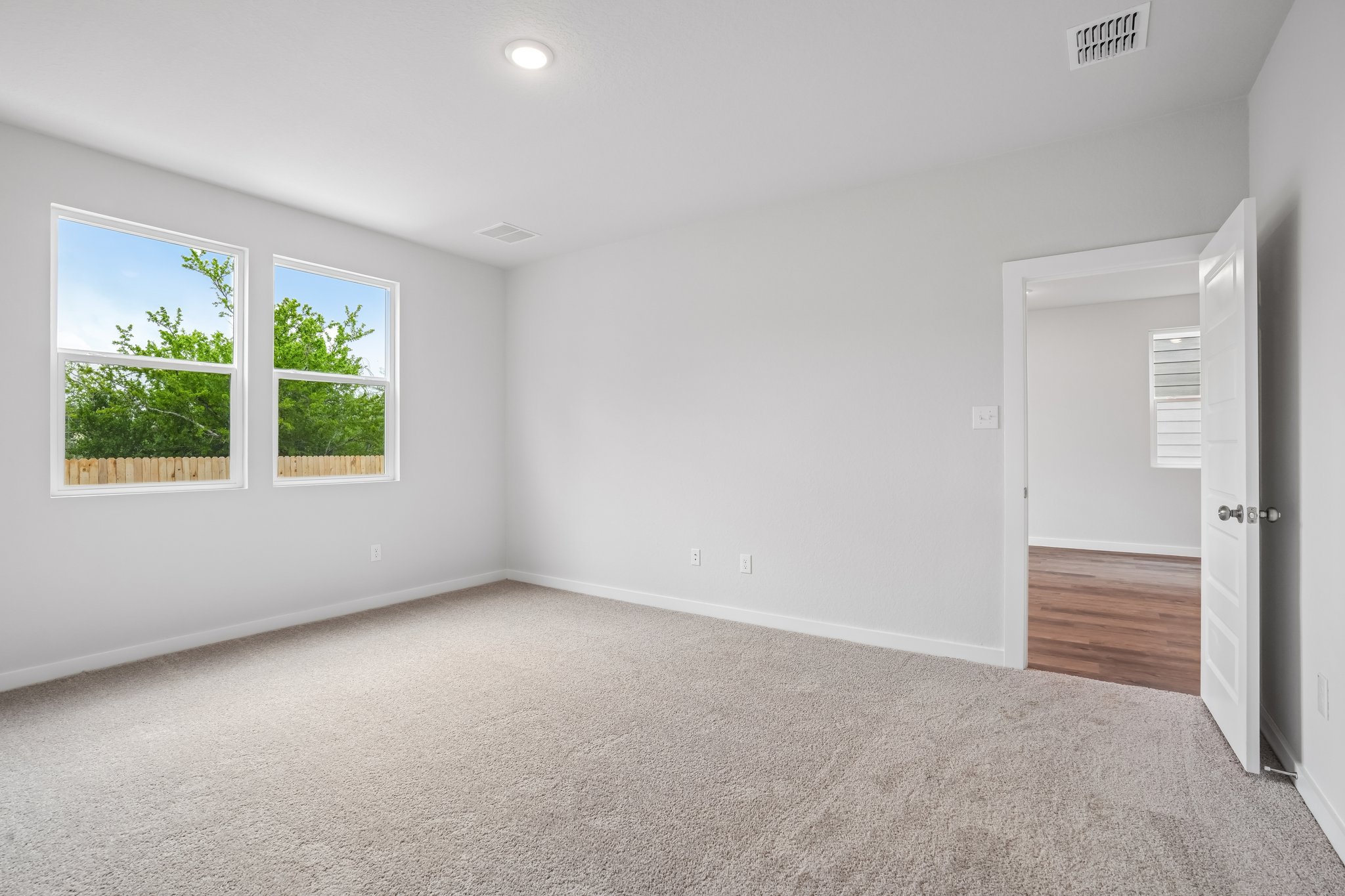 A room with windows and a door.