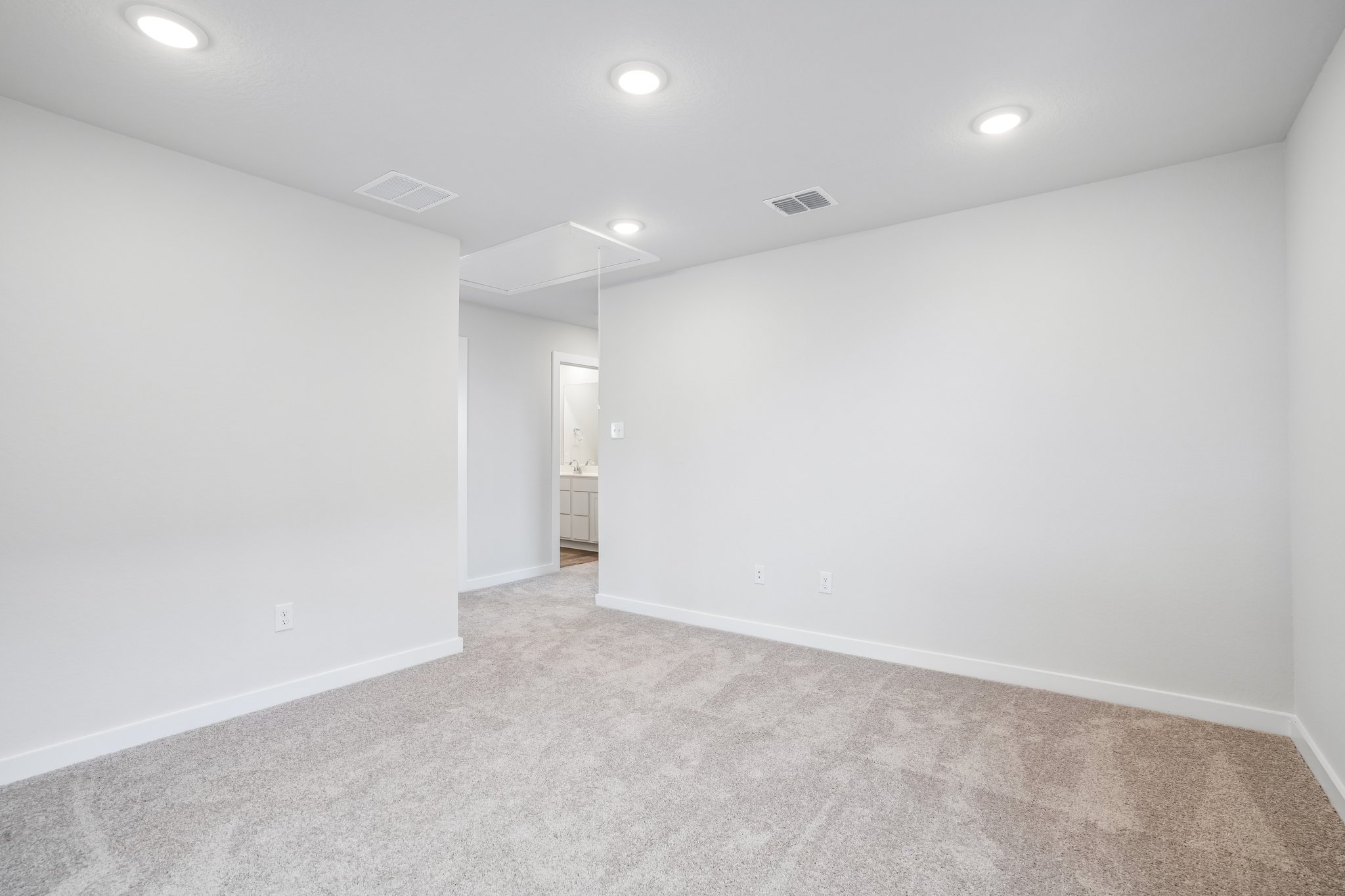 A hallway with white walls.