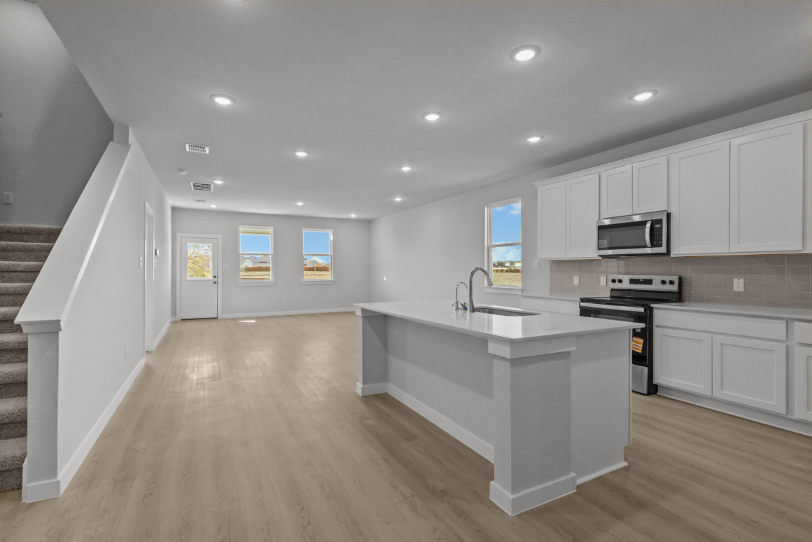 A kitchen with white cabinets.