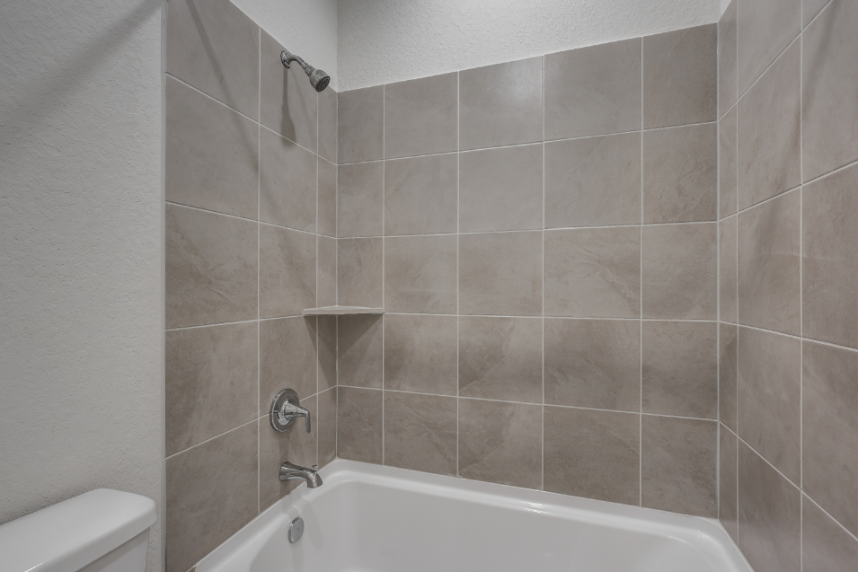 A bathtub in a bathroom.