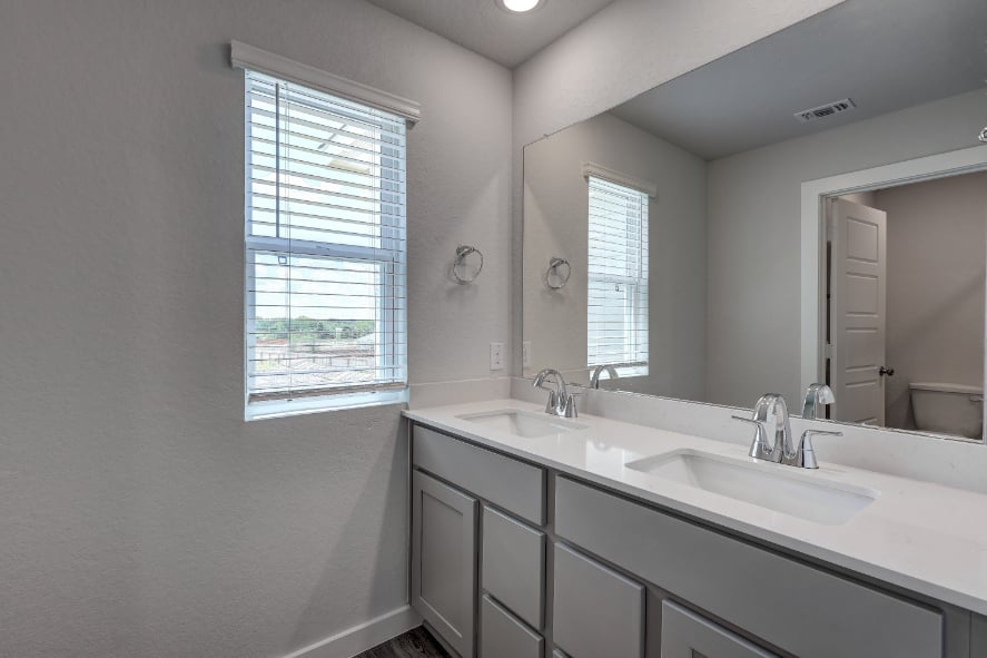 A bathroom with a large mirror.