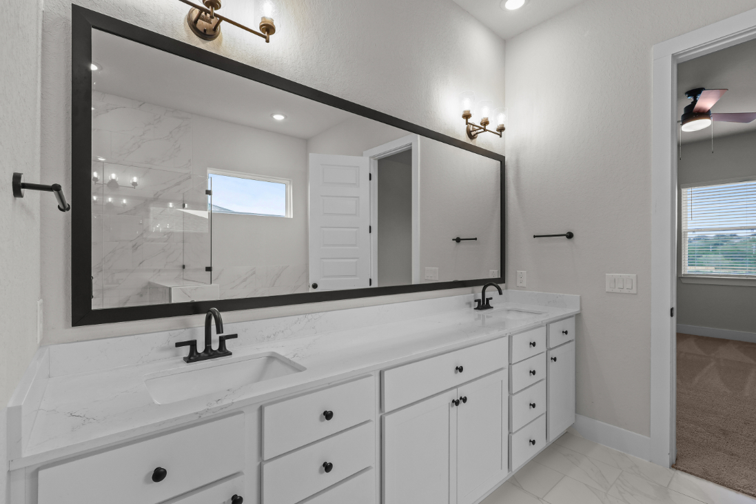 A bathroom with a large mirror.