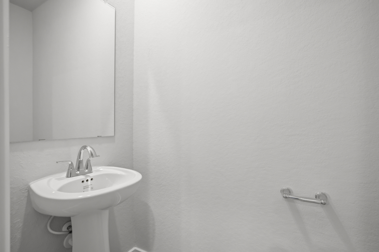 A bathroom with a sink and mirror.