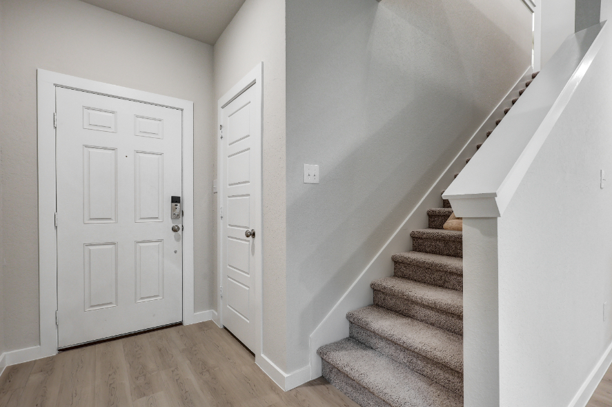 A staircase with white doors.
