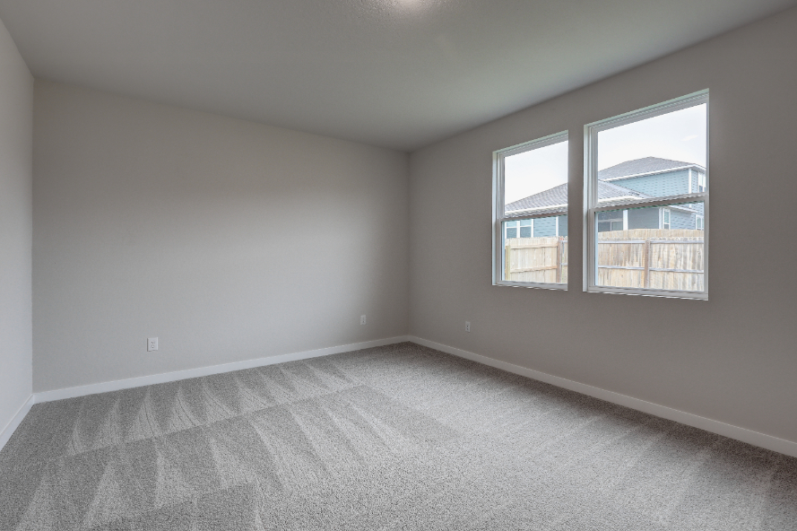 A room with a window and a carpet.