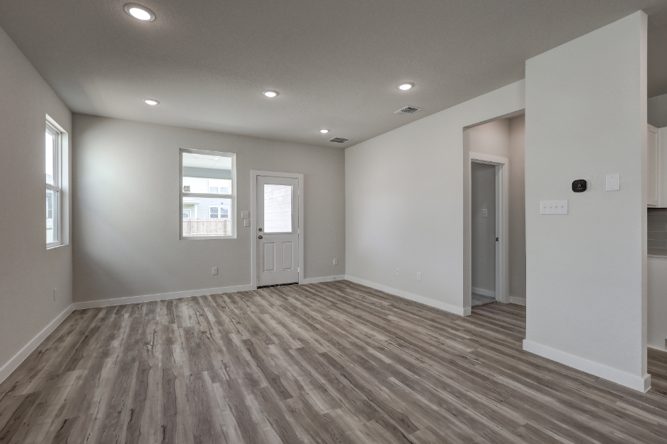 A room with a wood floor and white walls.