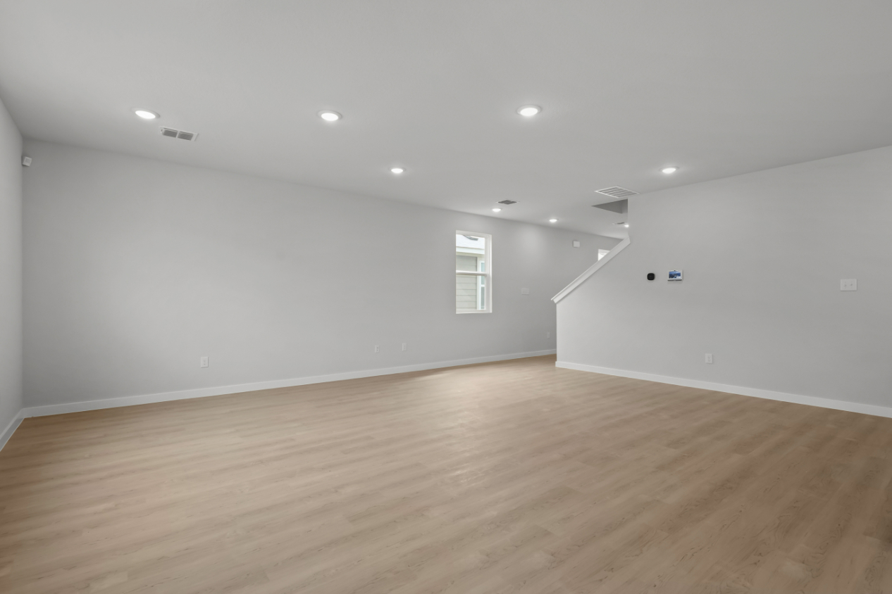 A room with a wood floor and a wood floor.