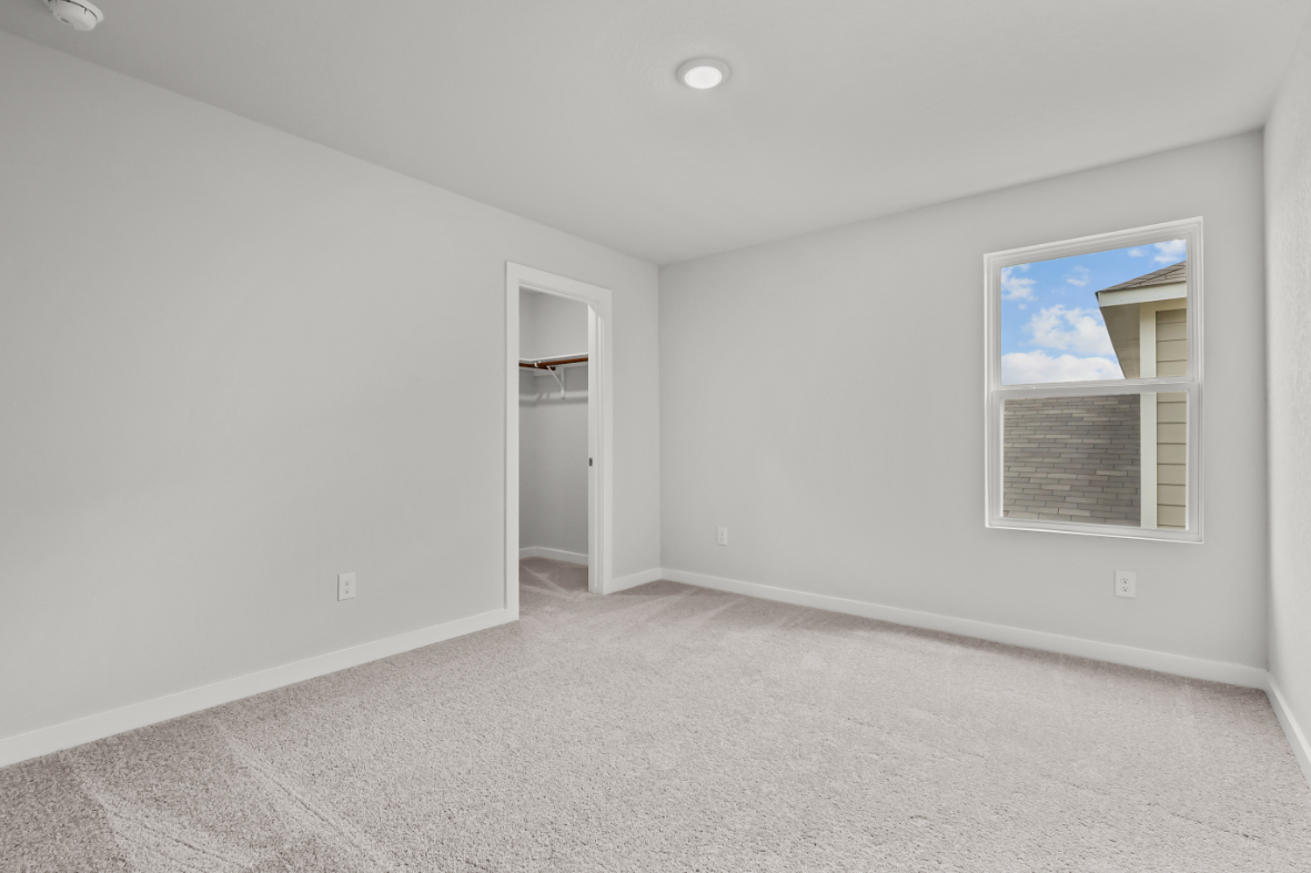 A room with a window and a door.