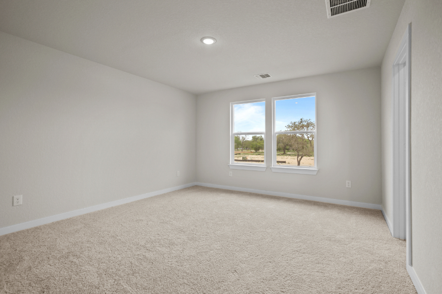 A room with a window and a carpet.