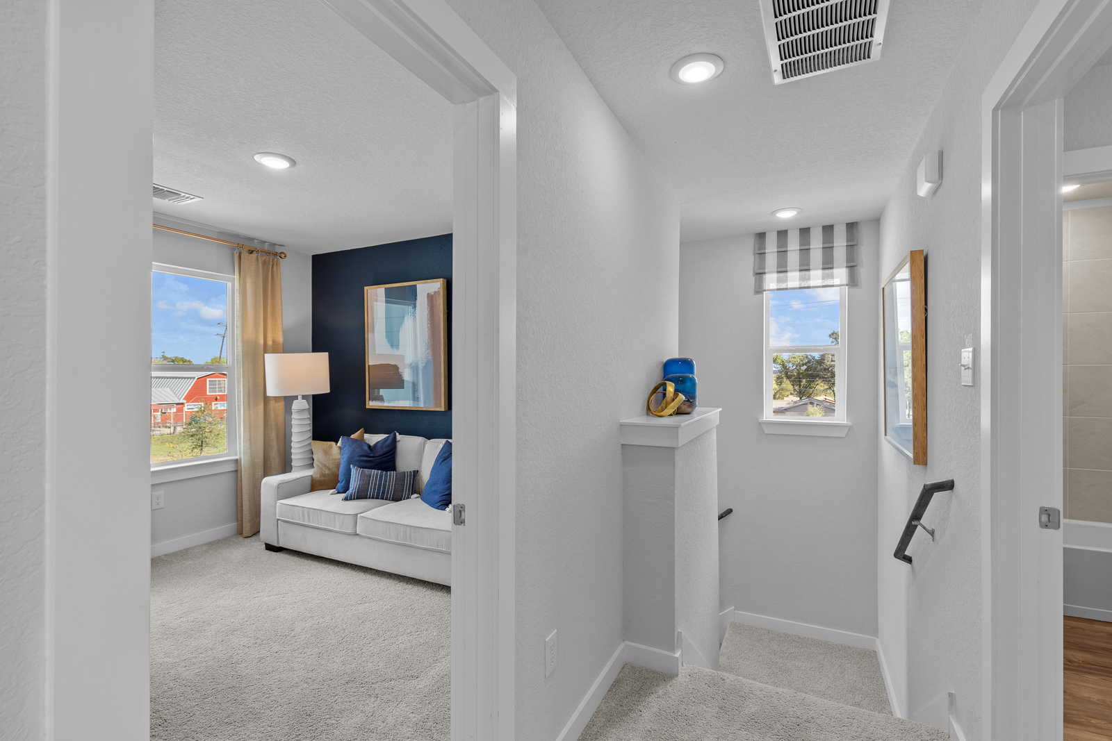 A living room with a couch and a lamp.