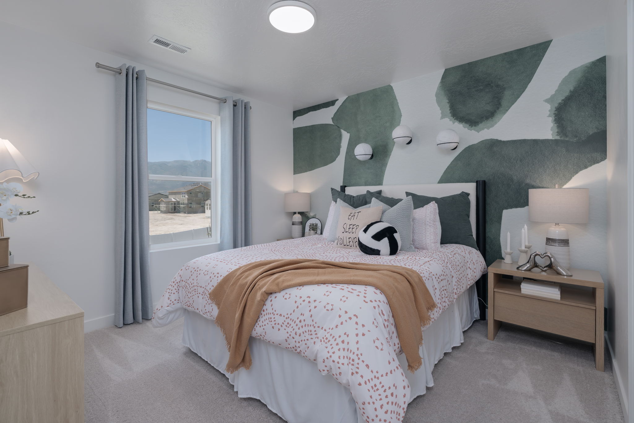 A bedroom with a bed and a window.