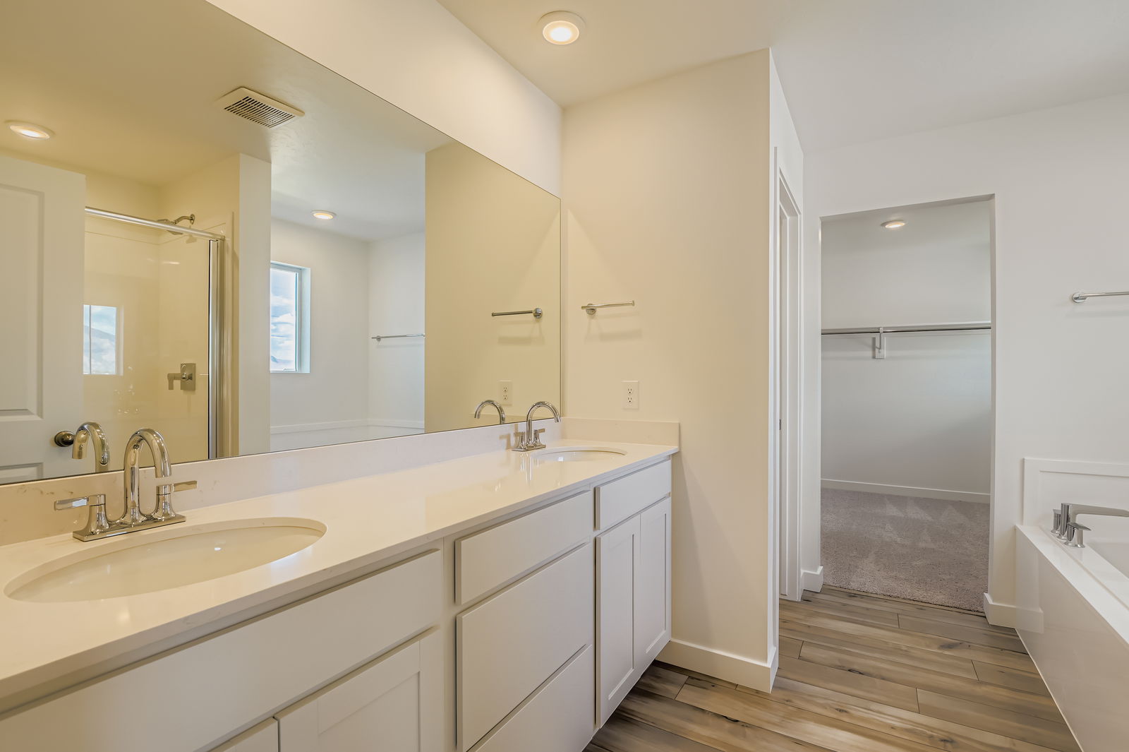 A bathroom with a sink and a shower.