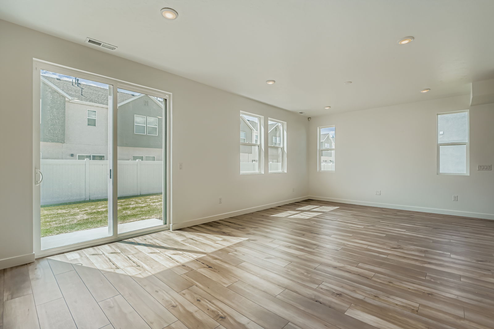 A room with a wood floor and a glass door.