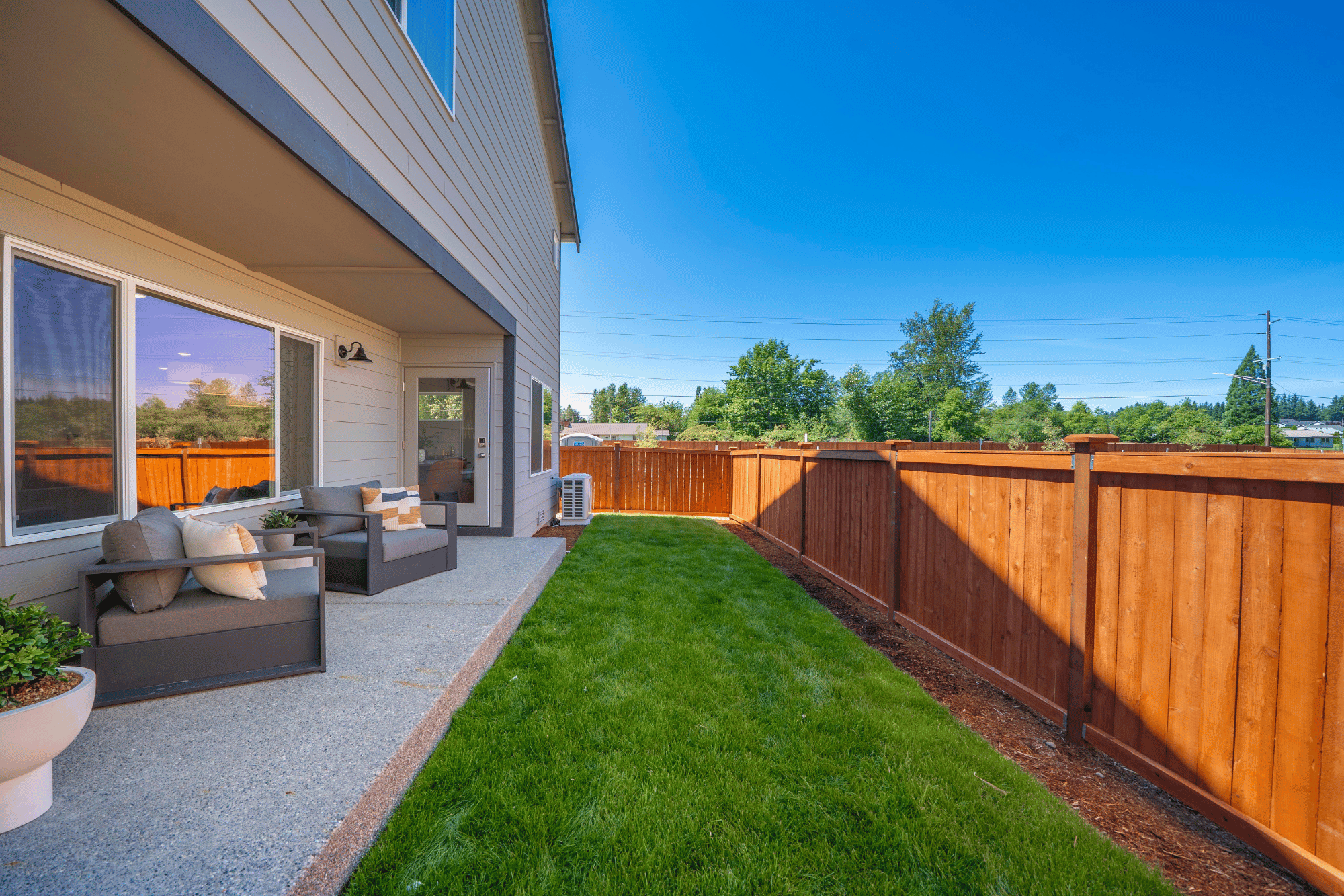 A backyard with a fence and a wood fence.